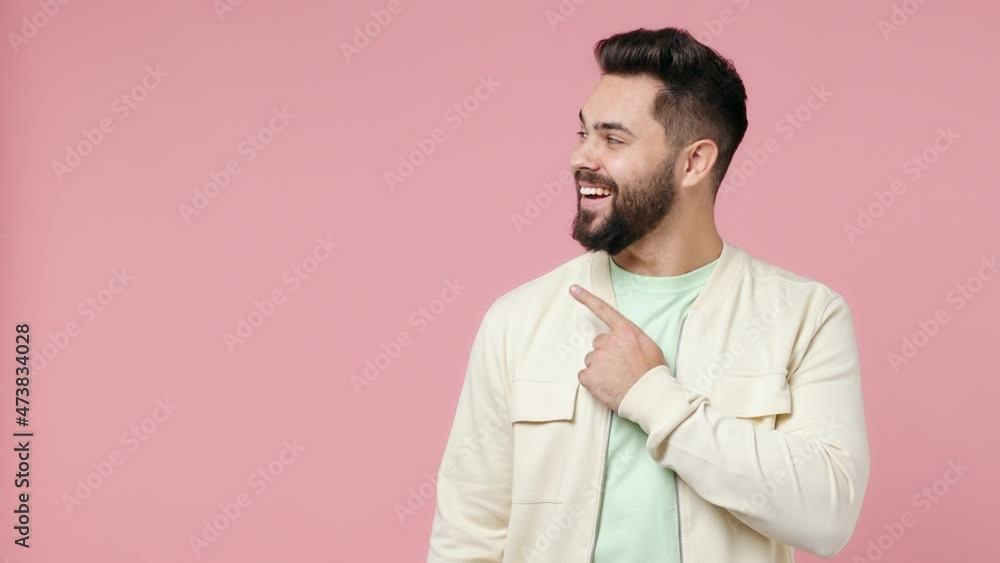 Promoter young bearded brunet man 20s wears white shirt pointing fingers hands aside on workspace copy space mockup promo commercial area isolated on plain pastel light pink background studio portrait Promoter young bearded brunet man 20s wears white shirt pointing fingers hands aside on workspace copy space mockup promo commercial area isolated on plain pastel light pink background studio portrait