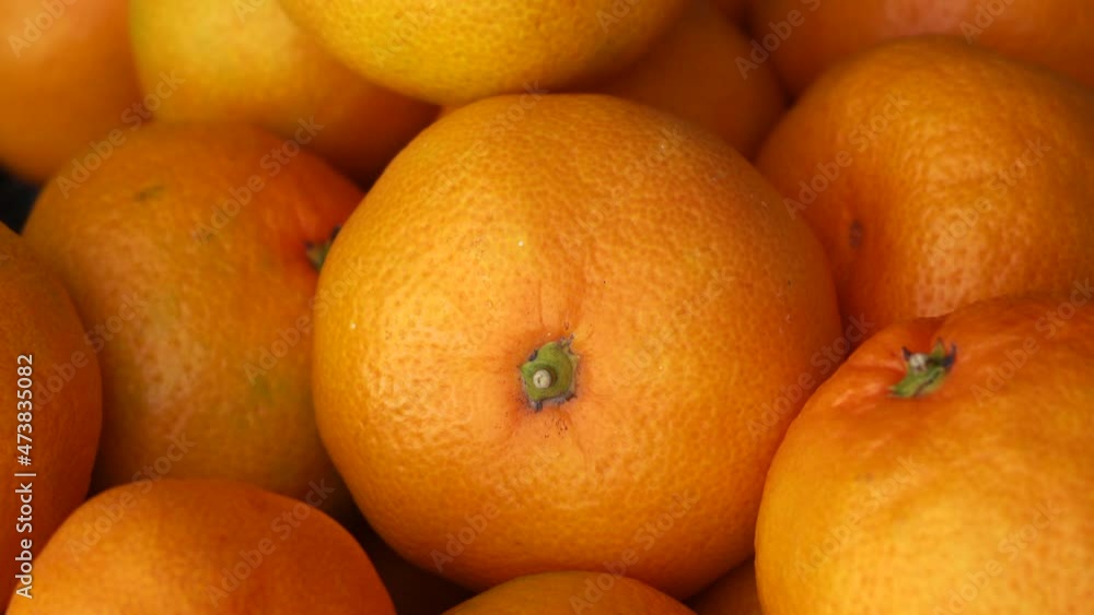 many tangerines lie close-up with an approaching camera many tangerines lie close-up with an approaching camera