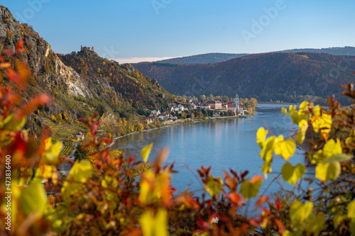 Beautiful autumn landscape with colorful grapevines, viewpoint over the beautiful village of Dürnstein, Wachau, Austria photo