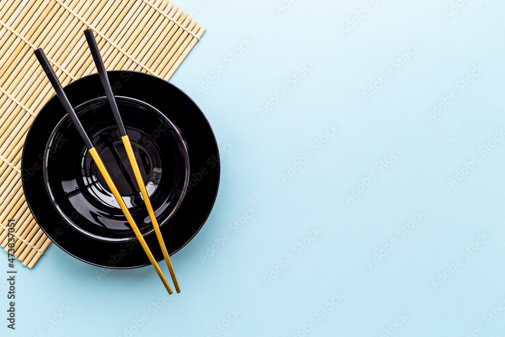 Black bowl with golden chopsticks for Asian tabble place setting Black bowl with golden chopsticks for Asian tabble place setting