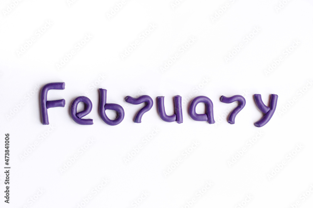 The word February is made of purple plasticine on a white background The word February is made of purple plasticine on a white background