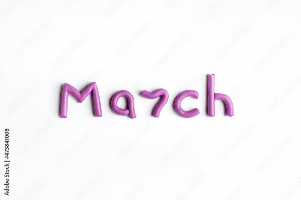 The word March is made of lilac plasticine on a white background The word March is made of lilac plasticine on a white background