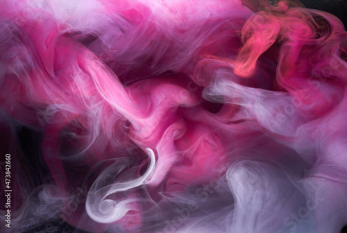 Pink smoke on black ink background  colorful fog  abstract swirling touch ocean sea  acrylic paint pigment underwater
