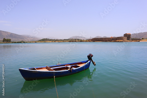 Butrint Lake with a boat in Butrint National Park, Buthrotum, Albania photo