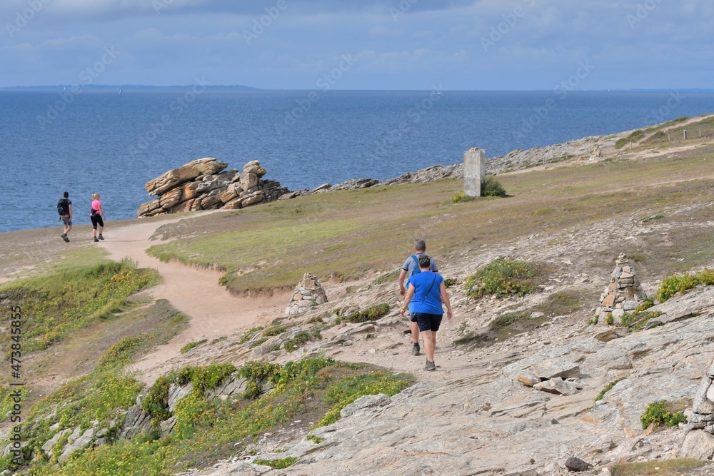 Fototapeta premium People,walking along the wild coast at the Quiberion peninsula in Brittany France
