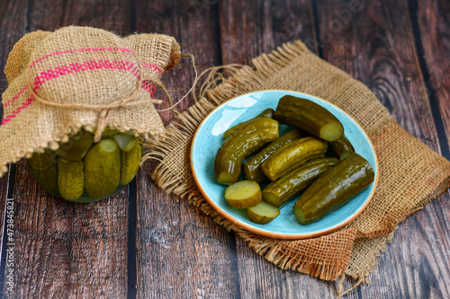 Obraz na plátne Plate of  homemade  organic bio pickled cucumbers  in vinegar with dill ,garlic