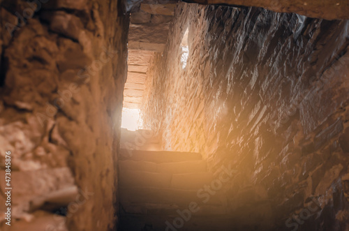 Ancient stone stairs. Exit dungeon. Light at end of tunnel.