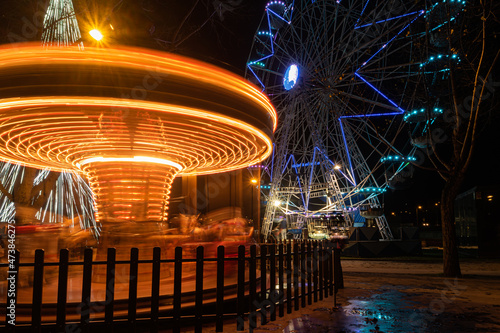 Fonte Nova's garden with Christmas market and colored ferris wheel near Ria de Aveiro at night