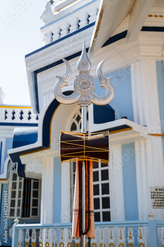 The Trident of Shiva. A silver symbol of the power of the god Shiva. An object of Indian culture.