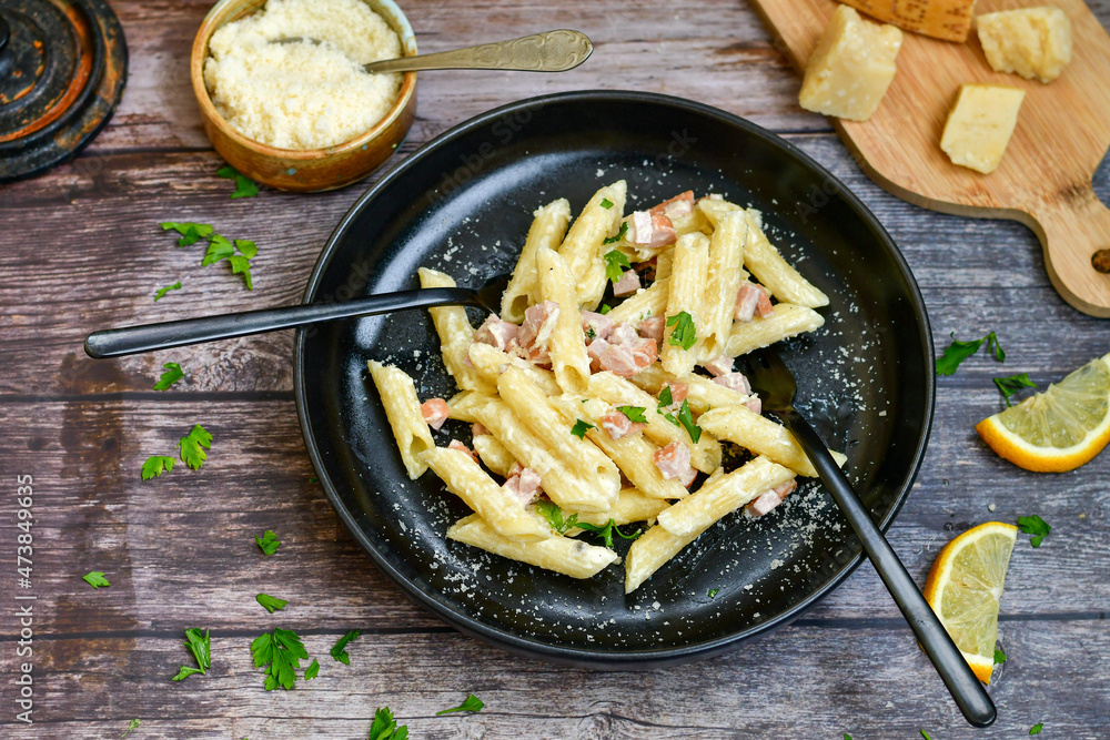 Fresh home made italian penne pasta alla carbonara with cream sauce , bacon,egg, parmesan cheese ,olive oil and black pepper) Fresh home made italian penne pasta alla carbonara with cream sauce , bacon,egg, parmesan cheese ,olive oil and black pepper)