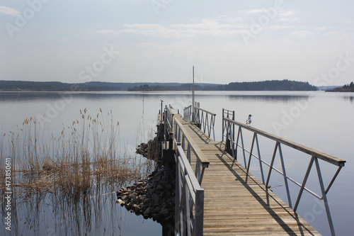 a wooden pier on a quiet serene lake. Peaceful rural landscape