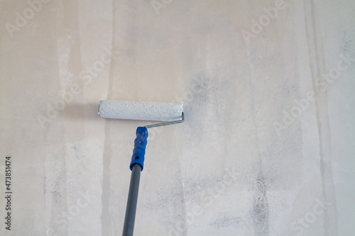 Primed with a roller with a primer putty wall before painting or gluing wallpaper photo