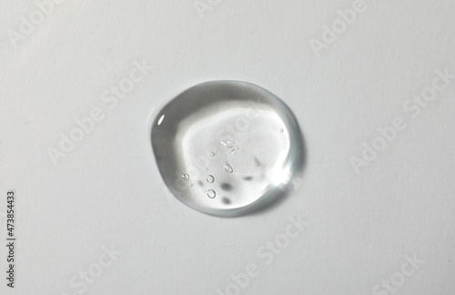 Sample of cosmetic gel on white background, top view photo