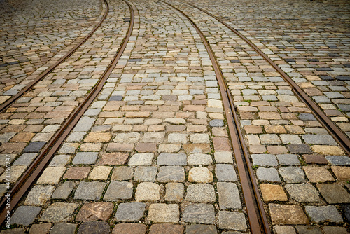 The antique tram railway track on stone pavement - perspective view