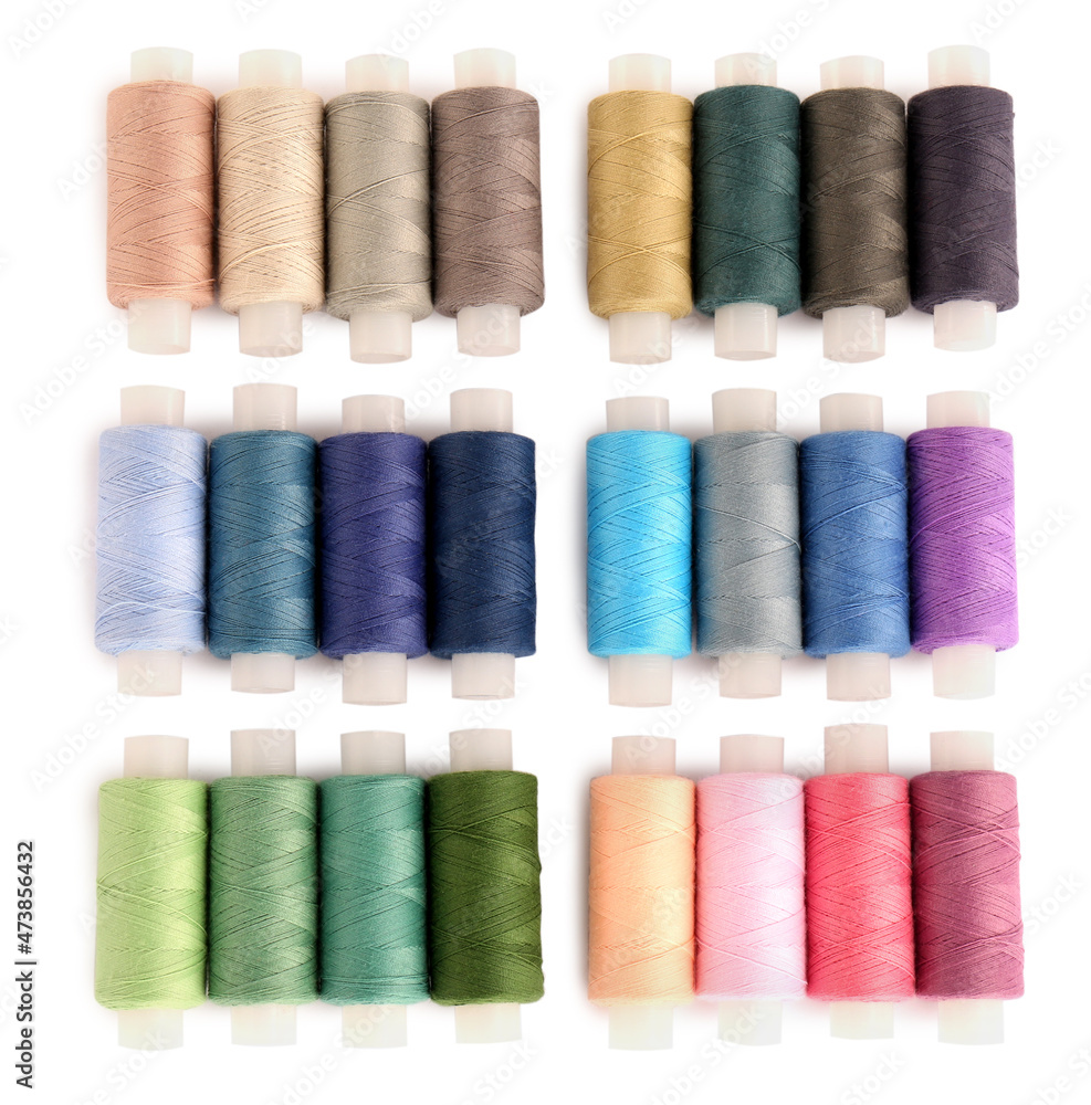 Set of colorful sewing threads on white background, top view Set of colorful sewing threads on white background, top view