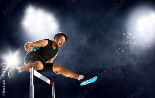 Man athlete hurdler running jumping over hurdles