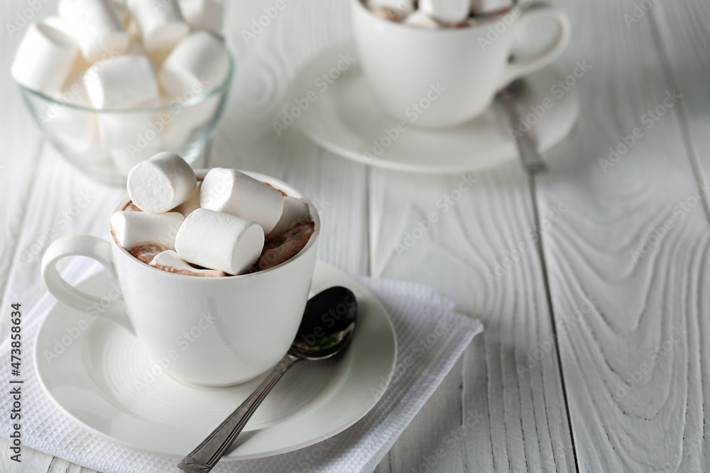 Mug with hot chocolate and marshmallows on wooden table Mug with hot chocolate and marshmallows on wooden table