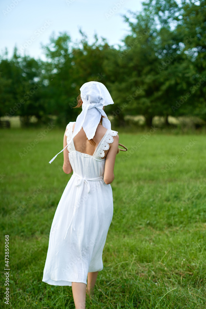 Woman in white dress in the village outdoors Green grass Farmer