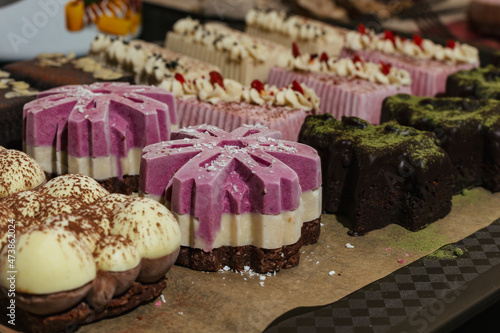 closeup various handmade vegan and sweet chocolate cakes on a kitchen tray