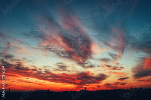 Colorful dramatic amazing sunset and city silhouette © gezginlobiya