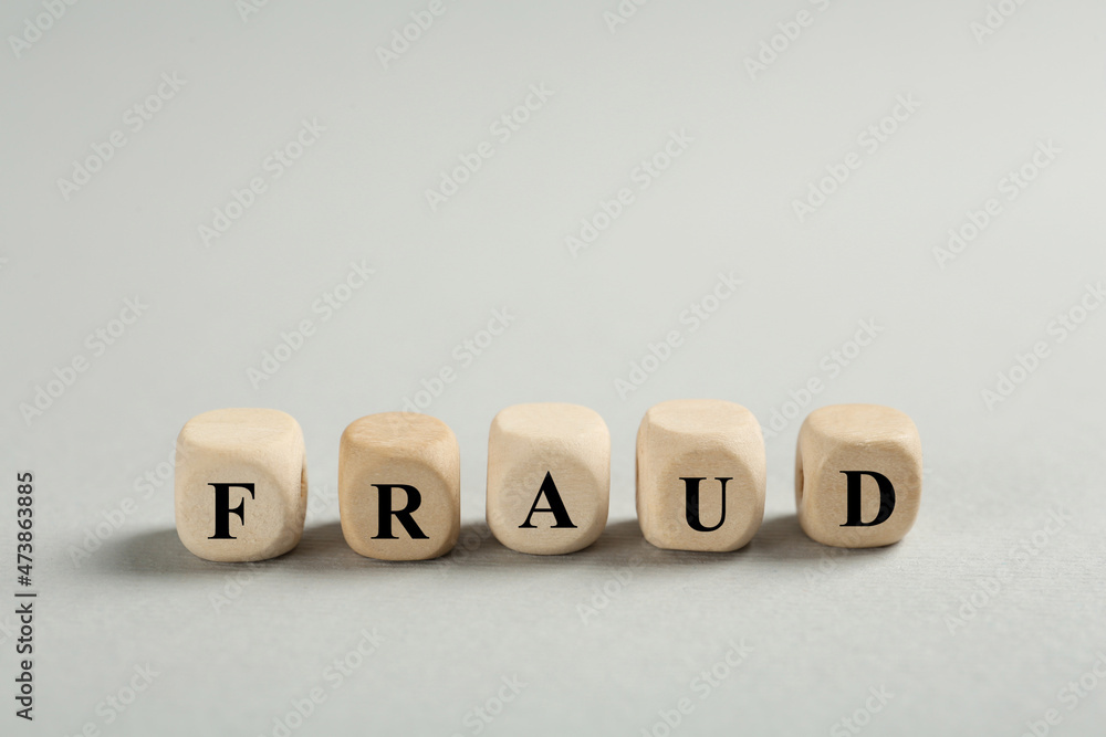 Word Fraud of wooden cubes with letters on light grey background. Space for text Word Fraud of wooden cubes with letters on light grey background. Space for text