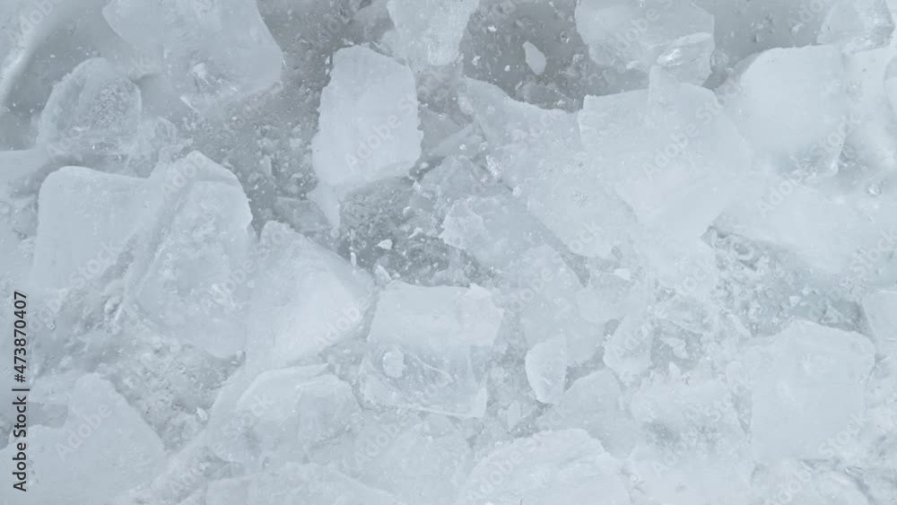 Super slow motion of falling crashed ice into white background. Filmed on high speed cinema camera, 1000 fps. Super slow motion of falling crashed ice into white background. Filmed on high speed cinema camera, 1000 fps.