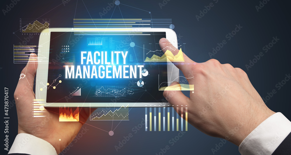 Fototapeta premium Close-up of hands holding tablet with business inscription