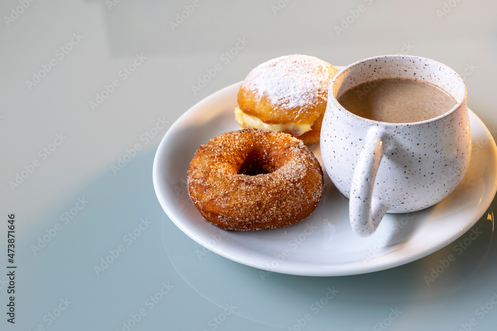Rustic porcelain cup with cappuccino, donuts and dream Rustic porcelain cup with cappuccino, donuts and dream