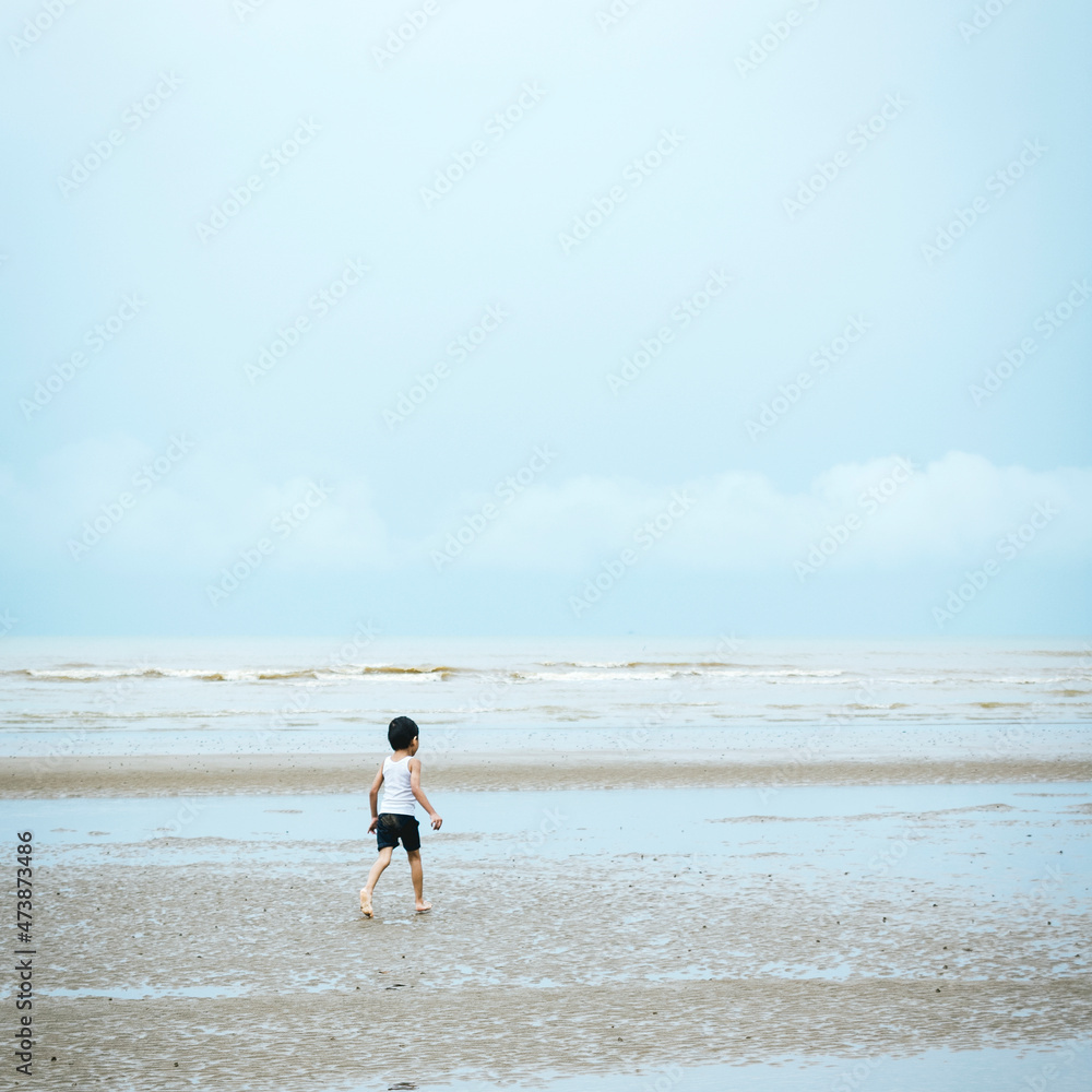 a little boy was running at the beach a little boy was running at the beach