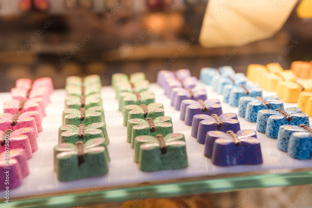 Pastel colored butterfly shaped candies in American macaroon shop Pastel colored butterfly shaped candies in American macaroon shop