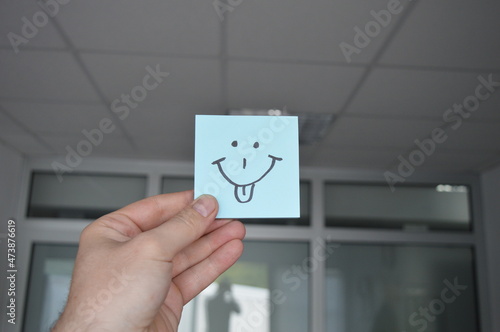 person holding a smile sign
