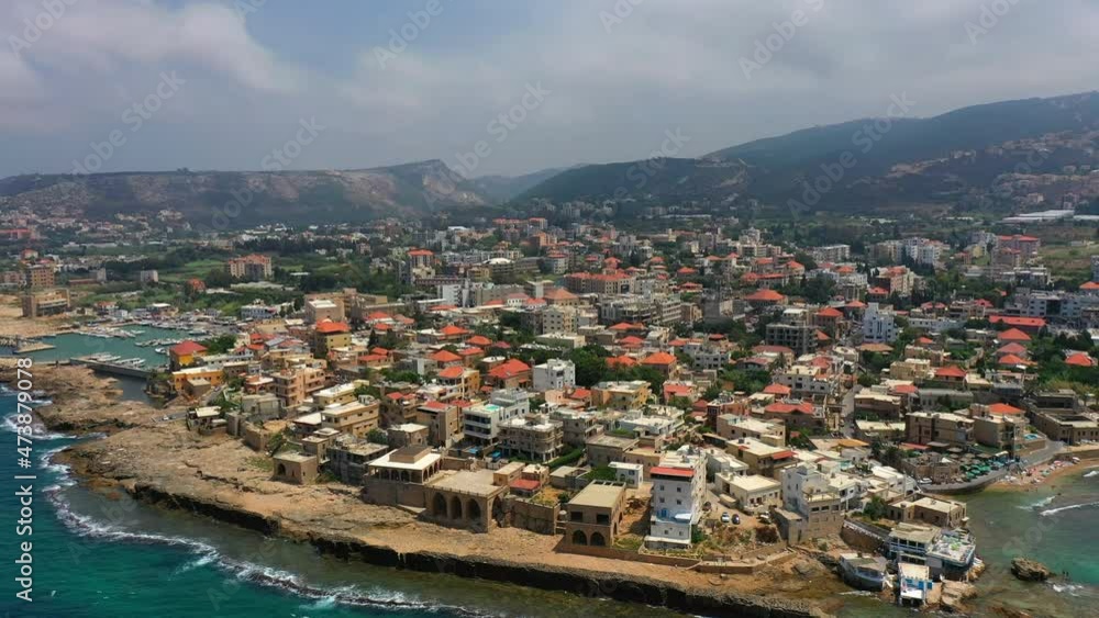 Aerial Panning Beautiful Shot Of Buildings In City Against Sky, Drone Flying Over Sea - Batroun, Lebanon Aerial Panning Beautiful Shot Of Buildings In City Against Sky, Drone Flying Over Sea - Batroun, Lebanon