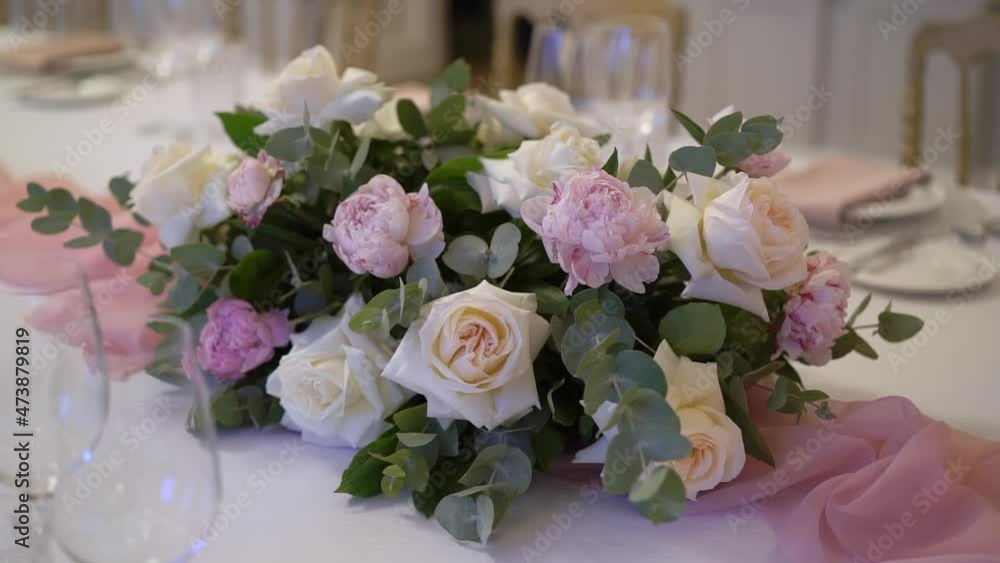 Served table in a restaurant for dinner, lunch or celebration. White tablecloth, plates, napkins and glasses, chairs. Holiday indoors. Empty with no people and food. Decorated with flowers for wedding Served table in a restaurant for dinner, lunch or celebration. White tablecloth, plates, napkins and glasses, chairs. Holiday indoors. Empty with no people and food. Decorated with flowers for wedding