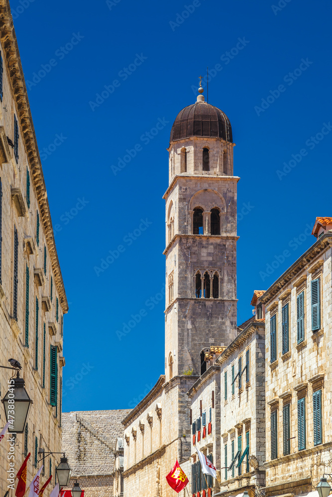 Tower of Franciscan Church and Monastery on Stradun street in the historic city center of Dubrovnik in Croatia, Europe.