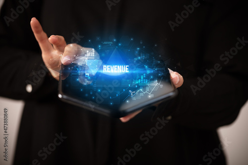 Businessman holding a foldable smartphone, business concept