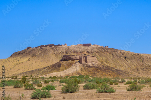 Panorama of desert fortress Ayaz-Kala in middle of spring Kyzyl Kum desert  Uzbekistan. Fortifications were built in 3-4 cent. BC. Main fortress  background  was built on high hill  up to 100 m high