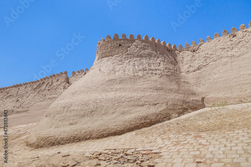 Tower of Ichan Kala, fortified historical center of Khiva, Uzbekistan. Shape of the tower reflects classic fortification traditions of Khorezm builders rooted in depths of centuries photo