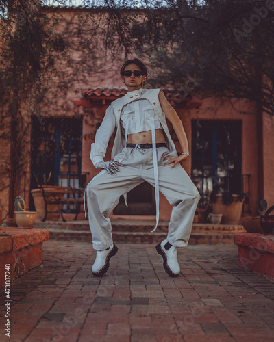 Male Model in all white outfit posing in unique ways around phoenix arizona having fun before sunset