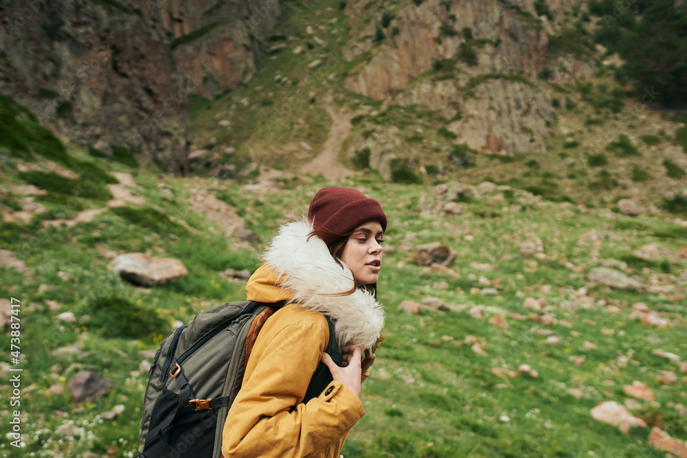 Naklejka premium woman hiker with backpack mountains travel adventure freedom