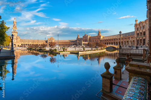 Morning sunlight view of the portico, tower and small lake at the Plaza de Espana, or Spanish Square, in Seville, Spain. 
