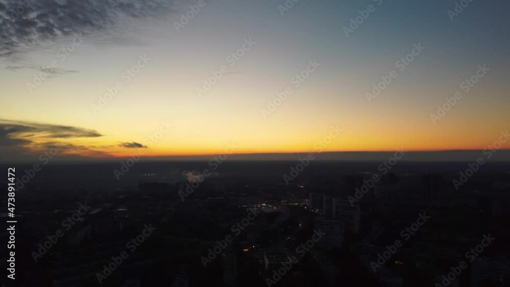 Aerial sunset evening flight above residential Kharkiv city Pavlove Pole district. Gray multistory buildings with scenic cloudy sky on horizon Aerial sunset evening flight above residential Kharkiv city Pavlove Pole district. Gray multistory buildings with scenic cloudy sky on horizon