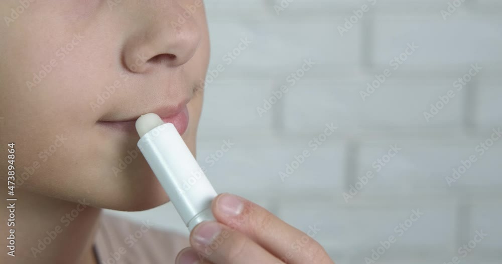 Girl paint her lips. A child makes beauty with a lipstick in the room. Girl paint her lips. A child makes beauty with a lipstick in the room.