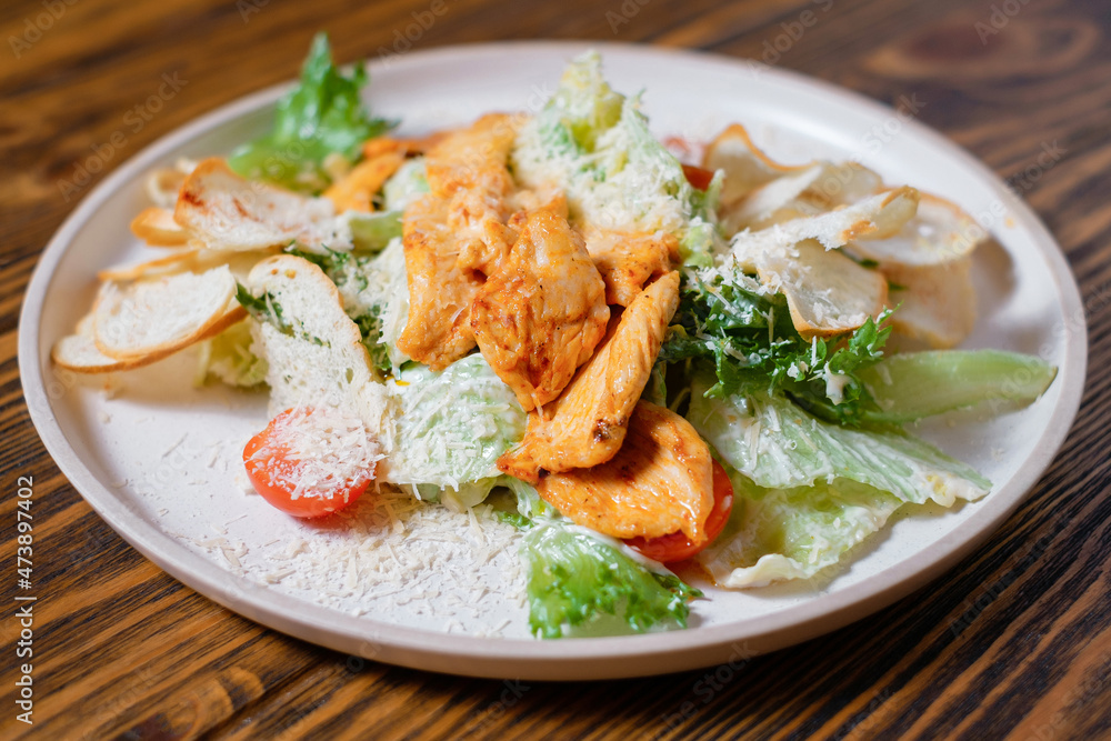 Caesar salad with chicken cheese and cherry tomatoes. Side view. Caesar salad with chicken cheese and cherry tomatoes. Side view.