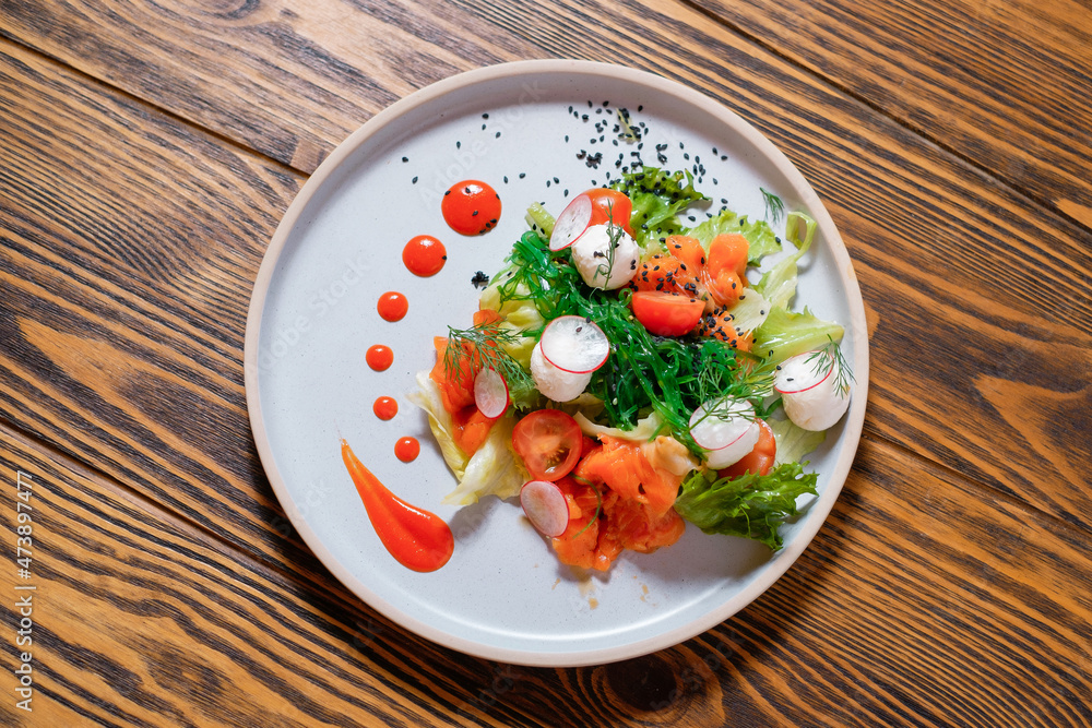 Vegetable salad with salmon, radish and tomatoes. Top view. Vegetable salad with salmon, radish and tomatoes. Top view.