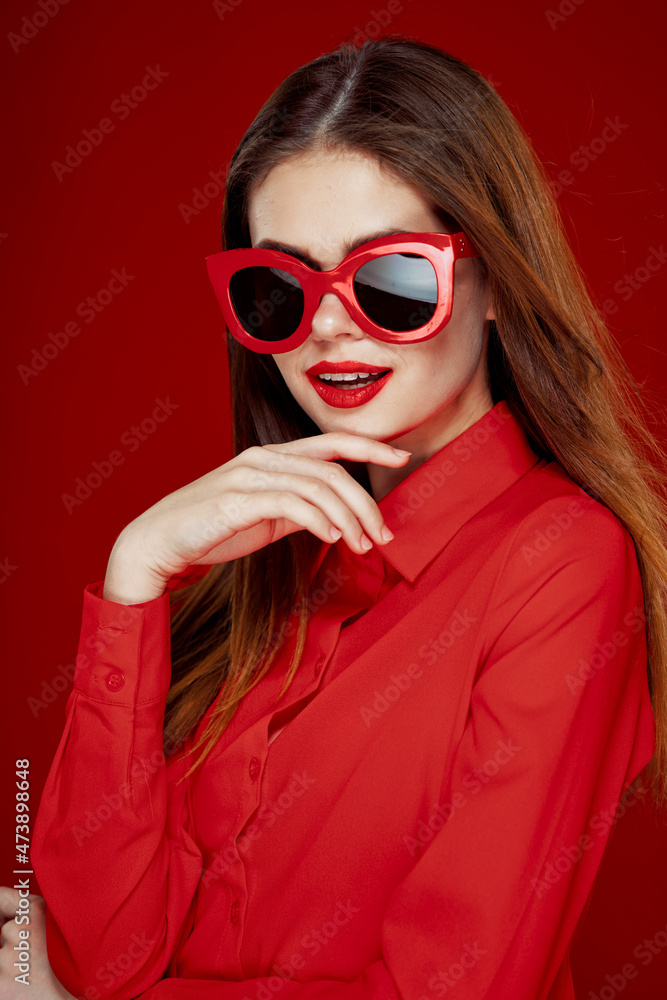 cheerful woman in a red shirt sunglasses Glamor close-up cheerful woman in a red shirt sunglasses Glamor close-up