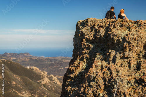 Hikers overlook Malibu and the Pacific Ocean in Malibu Creek State Park, California