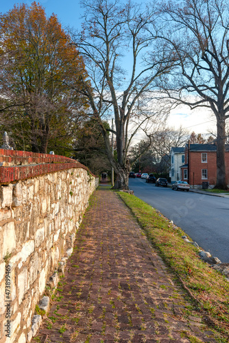 old brick pavement along an old stone wall