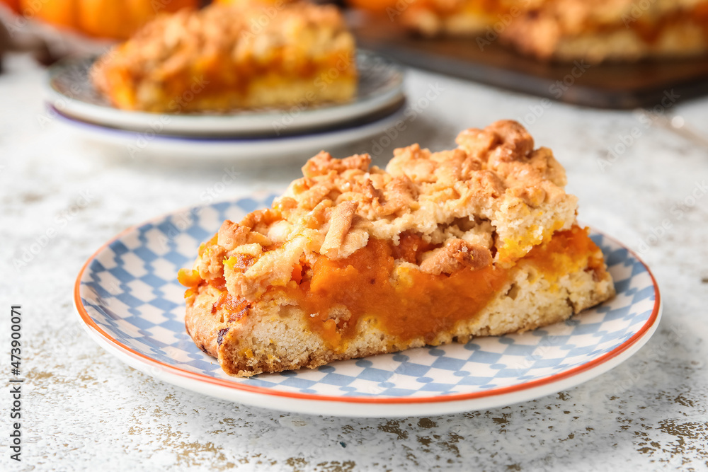 Plate with piece of fresh pumpkin pie on table