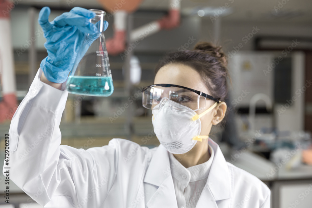 Female scientist looking at the scientific sample in the CDC laboratory. Female scientist looking at the scientific sample in the CDC laboratory.