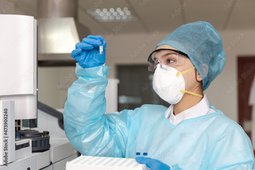 Female scientist looking at the scientific sample in the CDC laboratory. Female scientist looking at the scientific sample in the CDC laboratory.